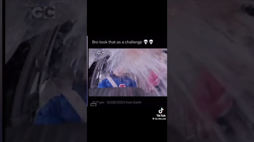 A person in a car, wearing a blue jacket, gets splashed with water from outside the window. Text overlay reads, "Bro took that as a challenge" with a skull emoji. Timestamp and TikTok watermark are visible.