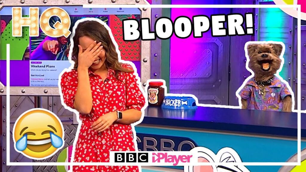 A woman in a red dress laughs with her hand on her face beside a puppet dog wearing a colorful shirt. The set features a "BLOOPER!" text, an emoji, and a colorful backdrop. BBC iPlayer logo displayed at the bottom.