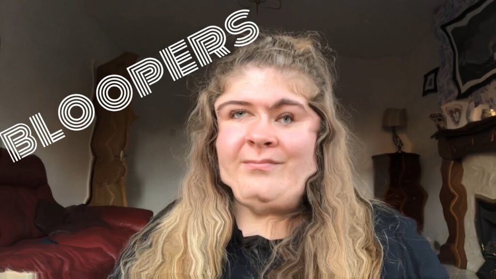 A person with long hair making a humorous facial expression, with the word "BLOOPERS" in bold letters overlayed on the image. The background shows a living room setting with furniture and soft lighting.